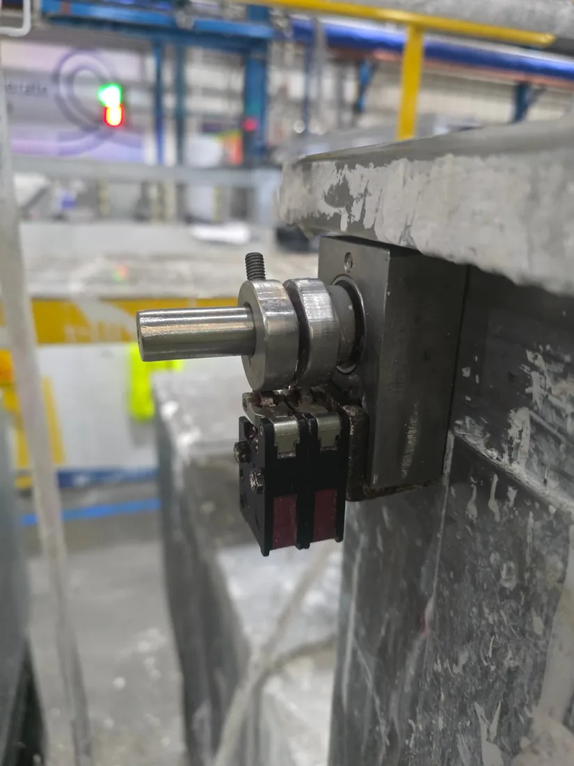 Ballcock control cam assembly after repair — cleaned shaft, cam collars and limit switches reset to their correct operating positions