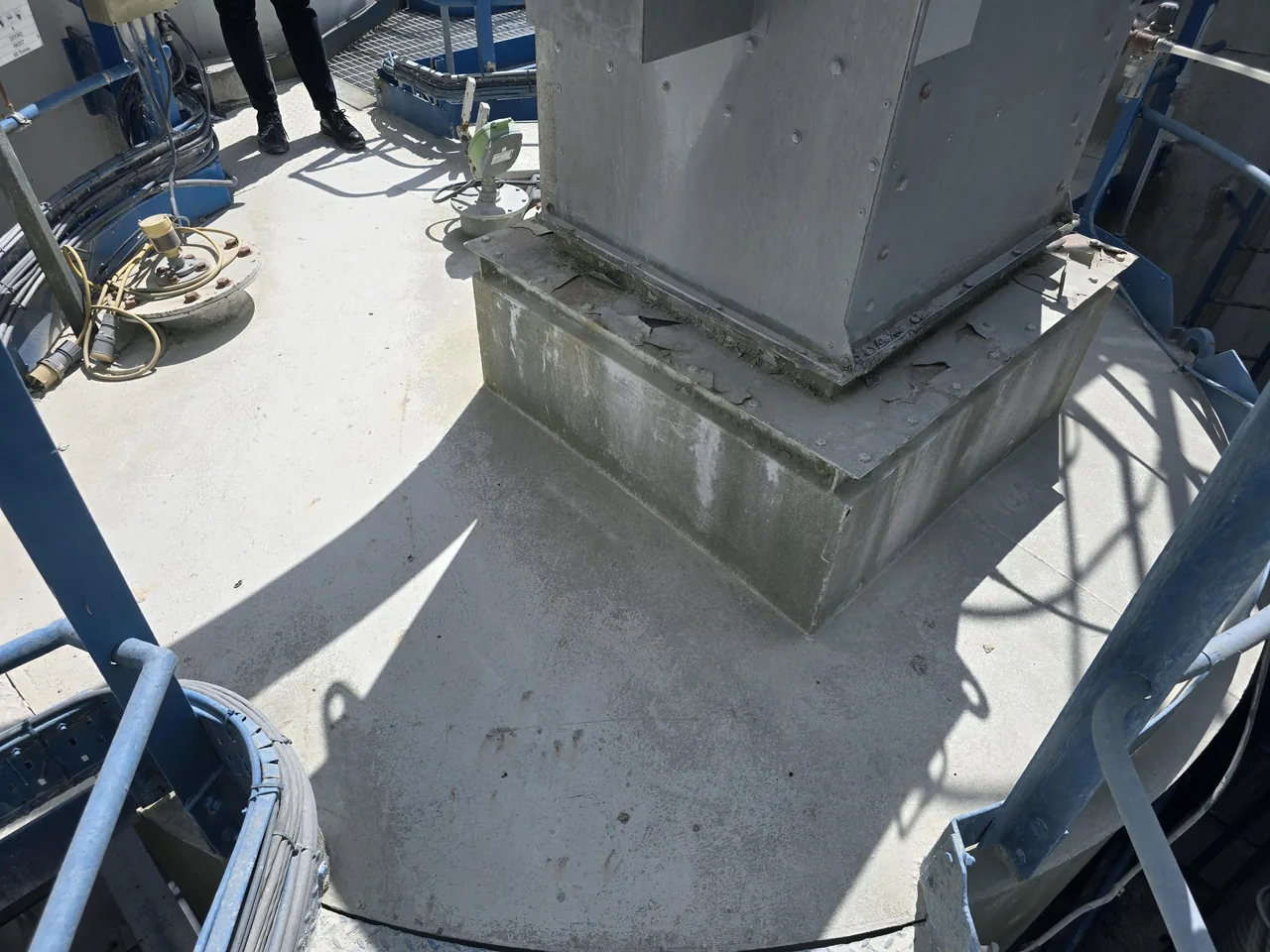 Silo walkway before treatment — worn, dull surface prone to slipping in wet and dusty conditions